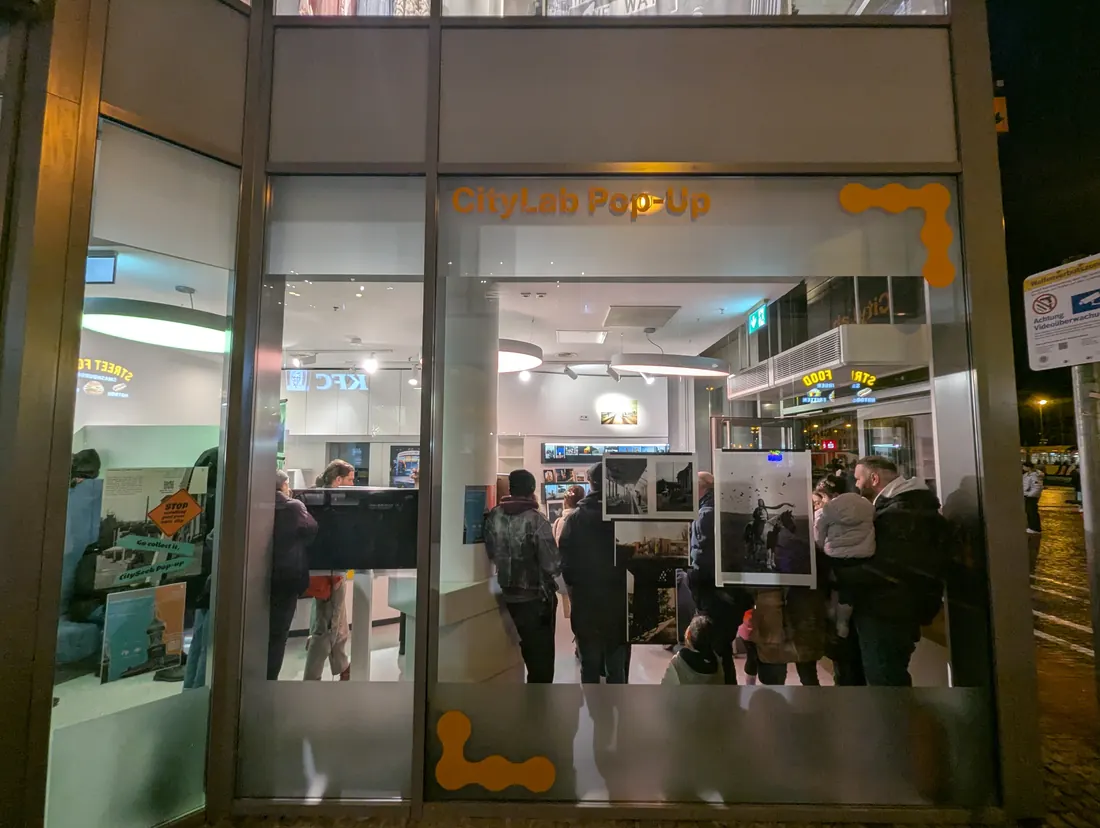 People gathering at the CitySeek CityLab pop-up at night